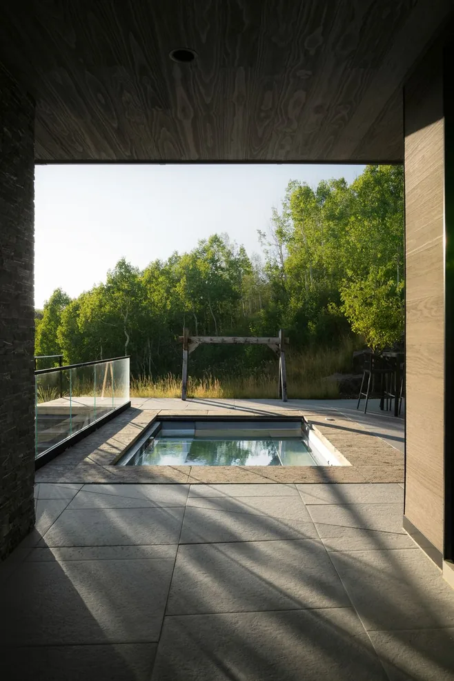 Pool and spa in low evening light framed by the covered terrace
