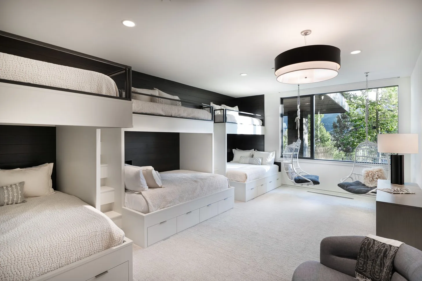 Bunk room with built-in beds, seating area and mountain windows