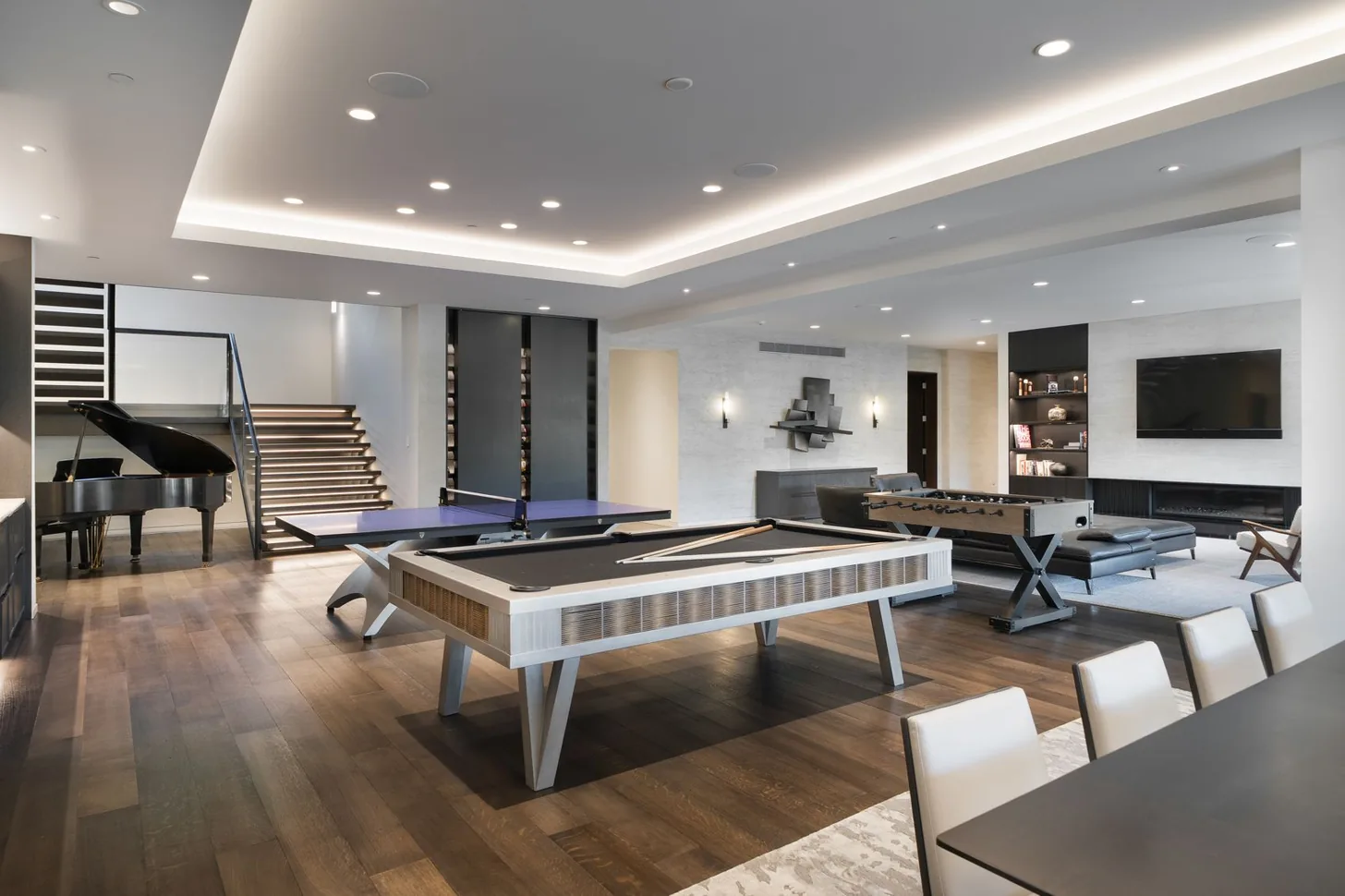 Game room with pool table, foosball and lounge seating