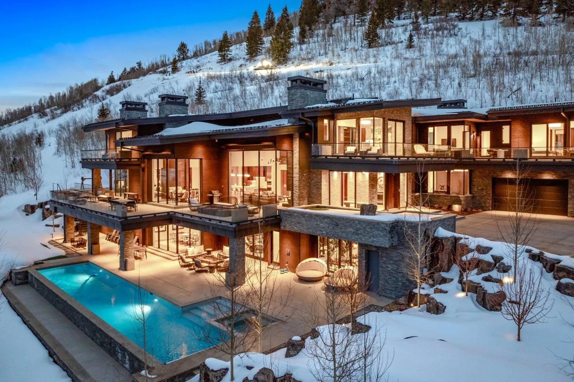 Heated pool and spa terrace at dusk with mountain views